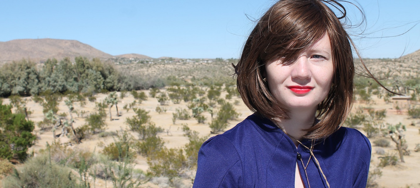 a woman in blue in the desert