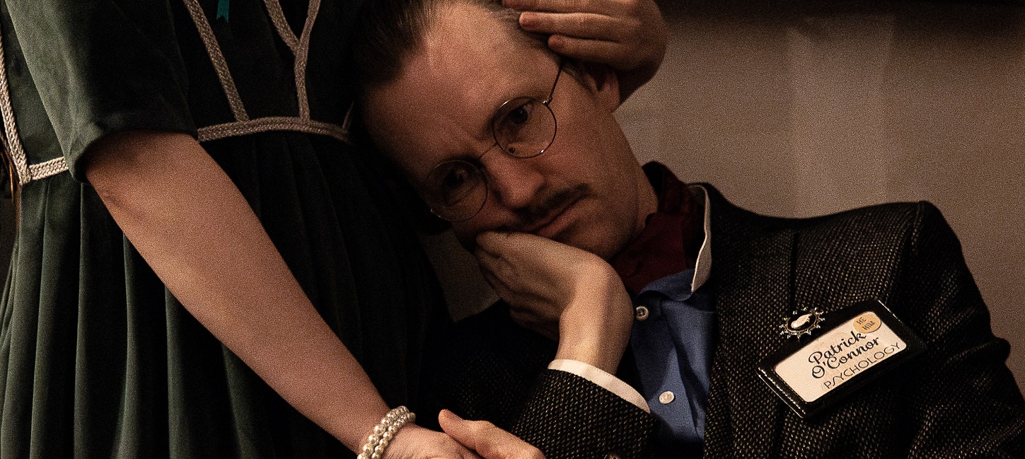 Photo of person seated being held by someone standing.